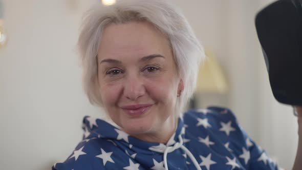 Happy Woman Taking Off VR Headset Smiling Looking at Camera alt