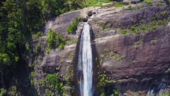 Diyaluma Falls and People on Top of Cliff in Rainforest alt