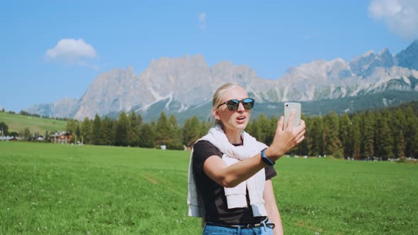 Close-up Shot of Woman Making Video Call From Beautiful Nature Park alt