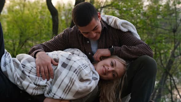 Close up couple in love with focus on girl. Portrait of smiling woman touched stroked by male hand. alt