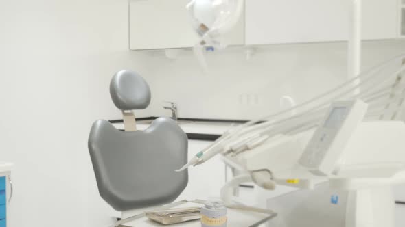 Lovely Young Woman Getting Into Dental Chair Smiling To the Camera