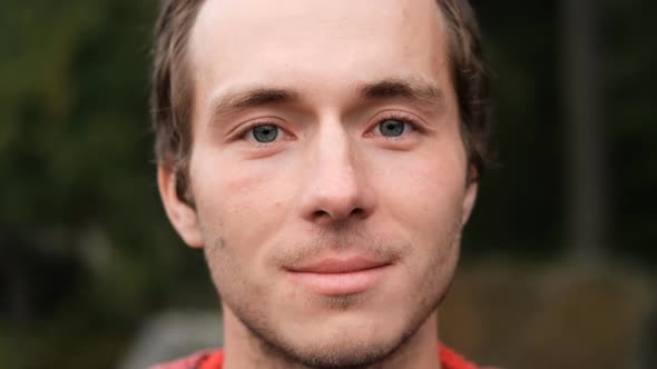 Slow Motion Portrait of a Young Man with Bristles Smiling alt