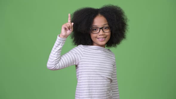 Young Cute African Girl with Afro Hair Showing Something alt