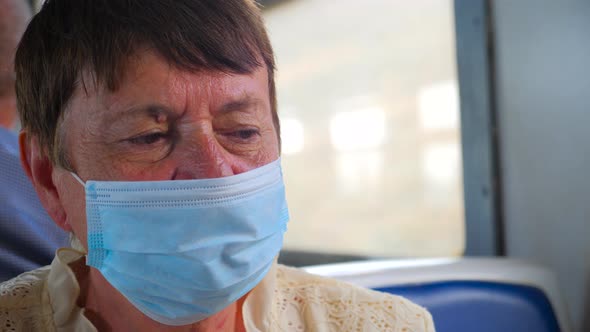 Exhausted Tired Old Woman Wearing Facemask, Protective Mask. Wearing Disposable Blue Medical Mask in
