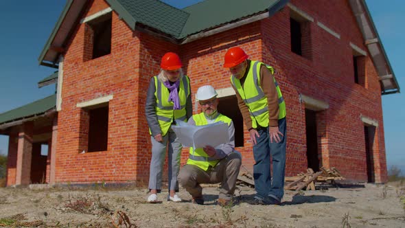 Realestate Agent Selling New House to Senior Grandmother Grandfather Showing Building Blueprints alt
