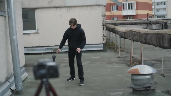 Sportsman Shows Strokes on Video Camera for Blog on a Roof. 