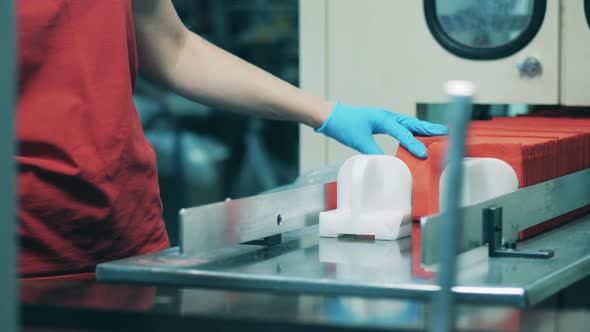 Factory Worker Sorting Red Paper Napkins at a Factory alt