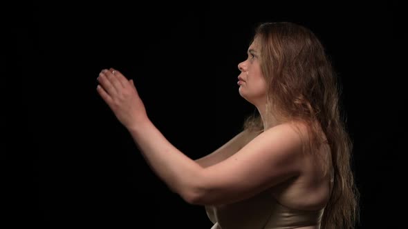 Side View Sad Obese Woman in Underwear Looking at Camera Turning Away Clasping Hands Praying alt