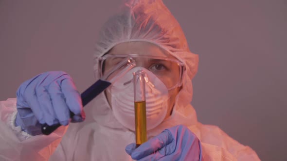 Protected Scientist Pouring Liquid in a Laboratory. Research and Science Concept alt