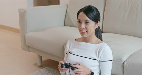 Woman play tv game at home alt