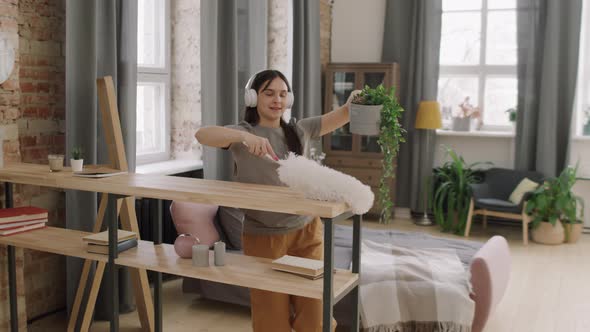 Carefree Woman in Headphones Dancing and Cleaning alt