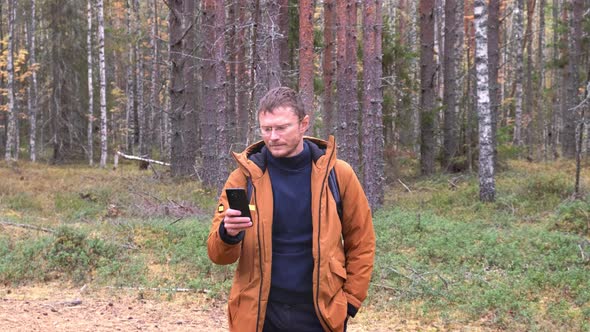 Portrait of a Caucasian Man with a Smartphone in His Hand