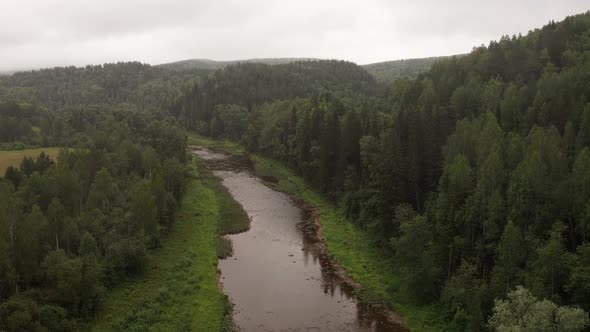 Aerial View of Beautiful River Inzer at South Ural Surrounded By Coniferous Forest