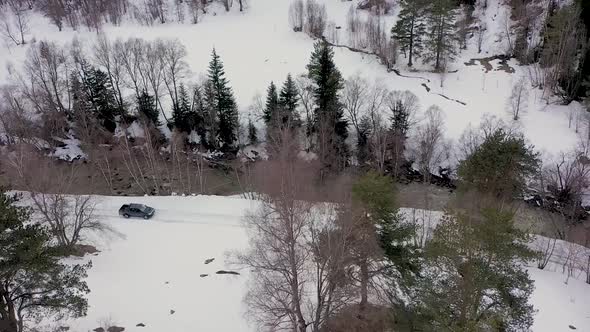 View from Above of Driving a Car in a Winter Paradise in the Mountains of Karachay Cherkessia. alt