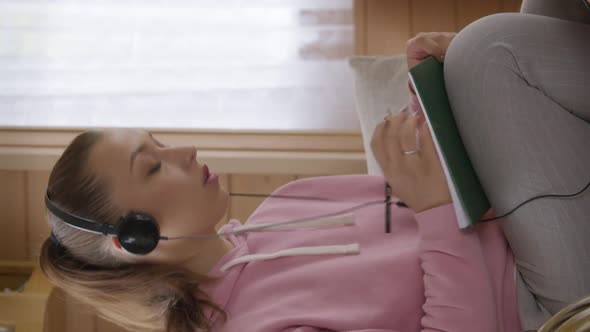 Vertical Shot Girl is Taking an Educational Course on a Laptop at Home During Quarantine