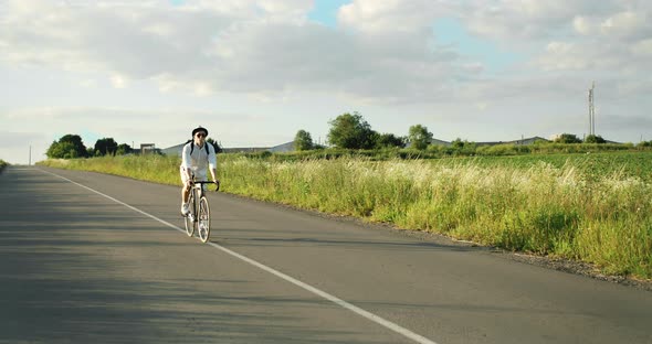 Man Riding Bicycle in Countryside