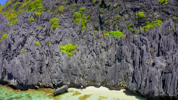 Jagged Limestone Cliffs of Matinloc Island at Palawan, Philippines alt