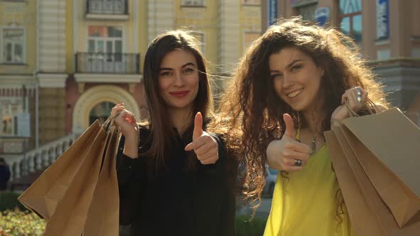 Female Friends Approve Their Shopping in the City alt