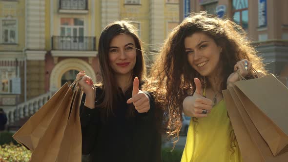 Female Friends Approve Their Shopping in the City