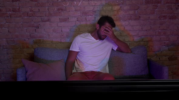 Handsome Dude Watching Something Scary On Tv alt