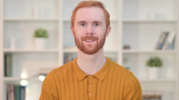 Portrait of Smiling Redhead Man Looking at Camera  alt