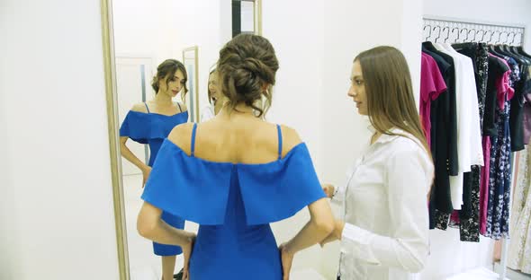 Happy Woman in Dress in Fitting Room