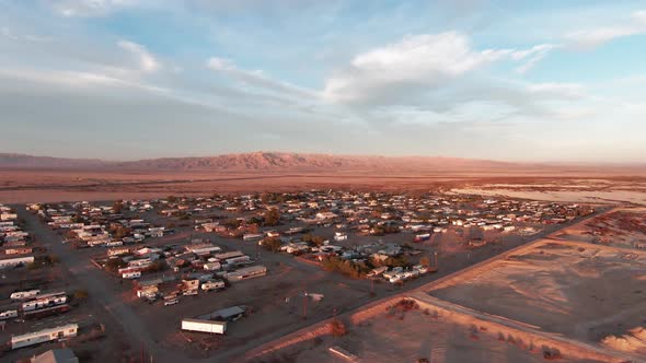 Small village full of trailers and prefabricated homes on Bombay Beach, Salton Sea, CA. Aerial drone alt