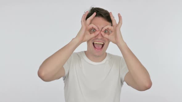 Funny Young Man with Binocular Gesture Searching on White Background alt