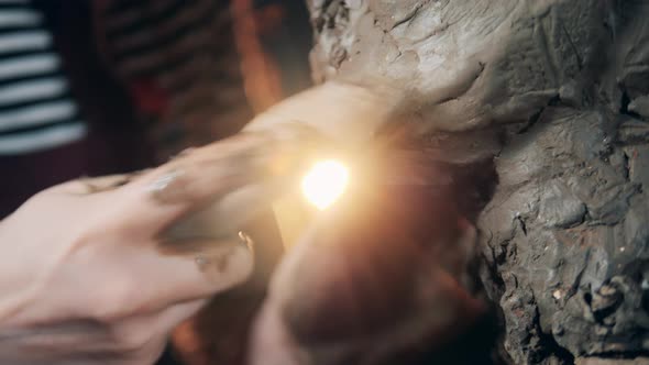 Clay Surface of a Sculpture is Getting Smoothed in a Close Up alt