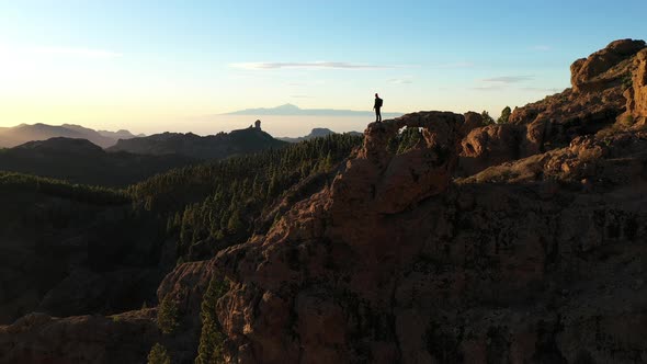 Man Looking At Dramatic Mountain Landscape alt