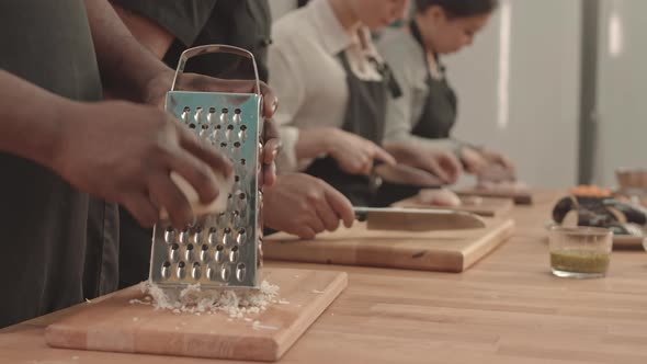 Grating Cheese in Professional Kitchen alt