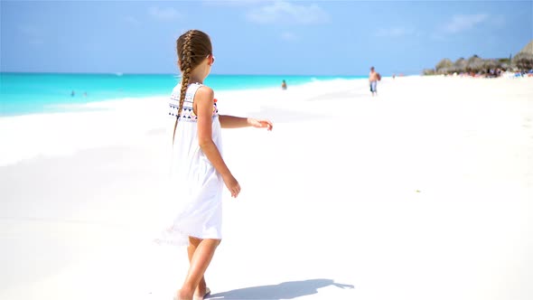 Little Tourist Girl Walking at Beach During Caribbean Vacation