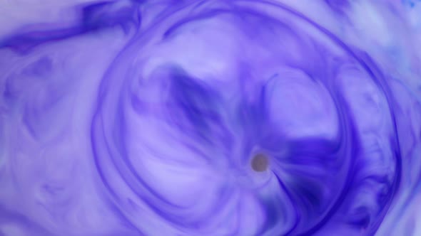 Ink in Water. Violet Ink Reacting in Water Creating Abstract Background.