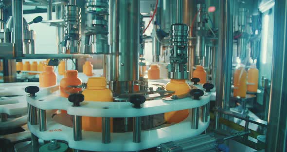 Machines in an automated chemical bottles production line alt