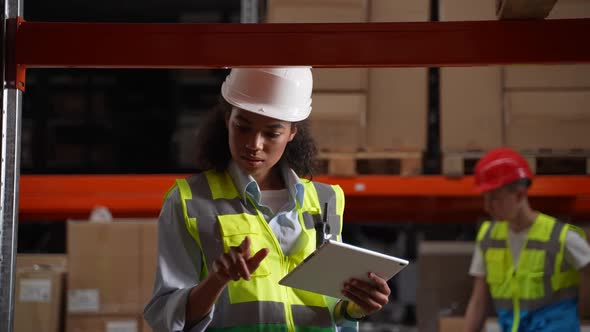 Warehouse Employee Taking Inventory on Tablet alt
