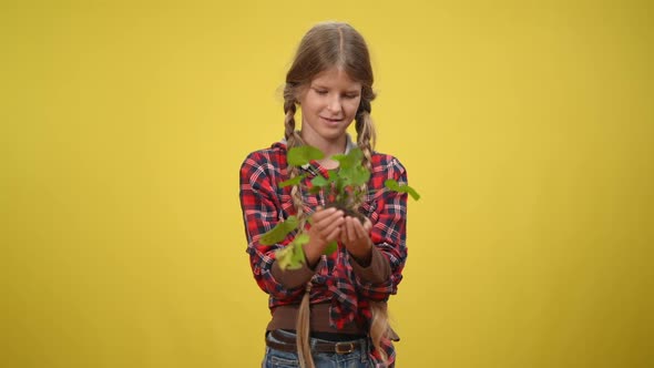 Medium Shot Smiling Teenage Ecoactivist Holding Green Herb Looking at Camera alt