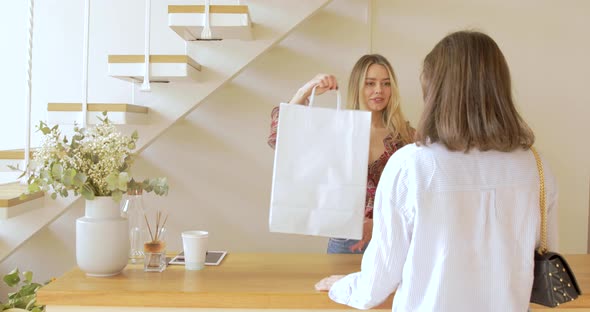 The Buyer is Taking Purchase In Fashion Clothes Boutique alt