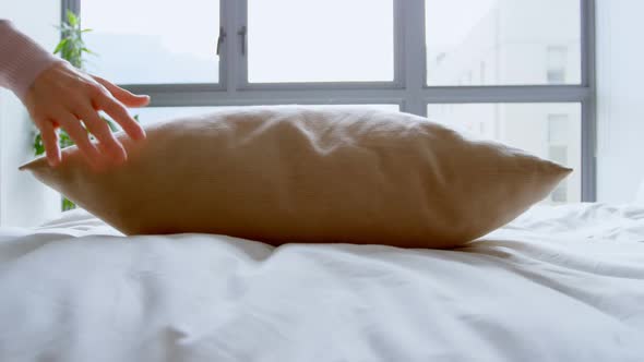 Woman holding pillow in bedroom 4k alt