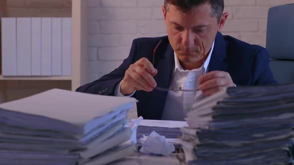 Accountant working on a file folder at his desk