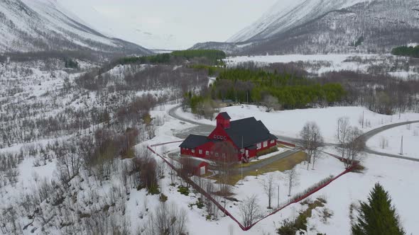 Drone shot orbiting an isolated and remote church in Norwegian mountains alt