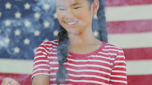 Girl waving sparkler on Fourth of July