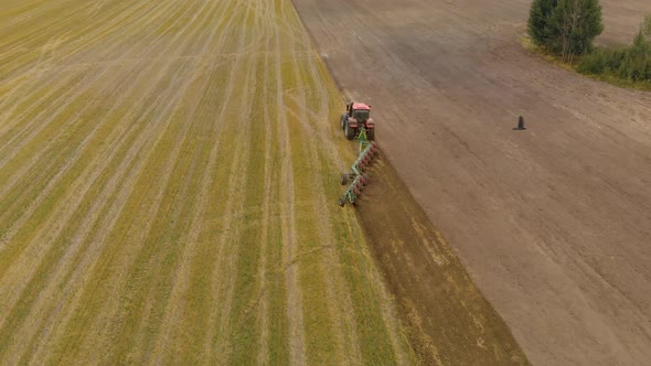 Tractor Cultivates Farmland with Multibody Trailer Plow alt