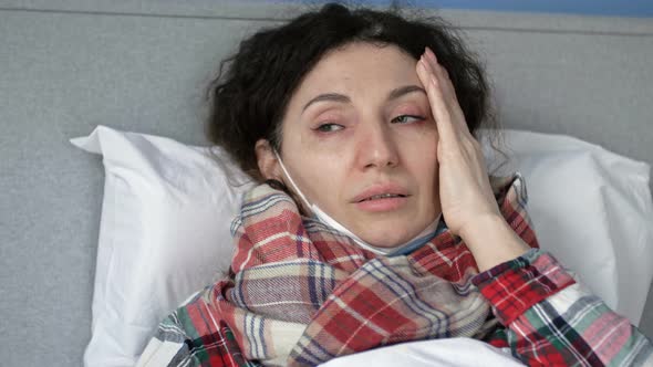 Portrait of a Sick Woman in a Medical Mask with Flu Cold or Coronavirus Symptoms alt