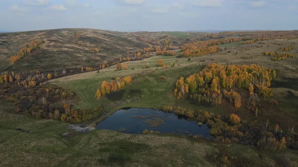 Aerial View of Blue Lakes and Green Forests on a Sunset Autumn Day