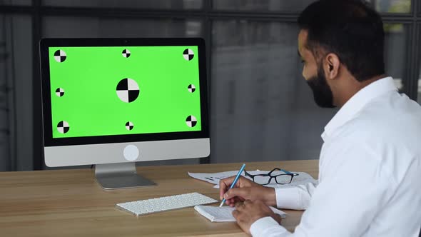 Side View of Indian Smart Man and Computer with Green Screen alt