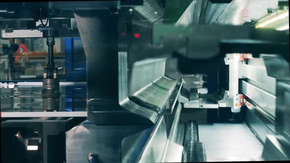 Side View of an Industrial Machine Shearing and Bending Metal alt