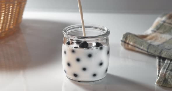 Milk Is Poured Into A Jar With Fresh Berries