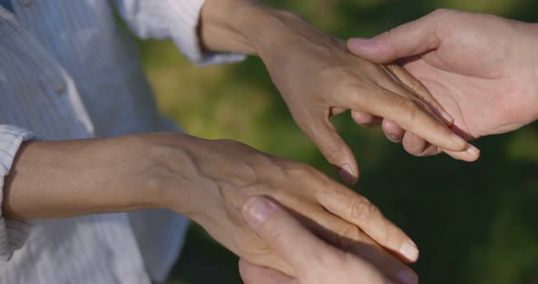 Top View of Mature Husband and Wife Hold Hands Outdoors alt