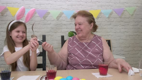 Grandmother Granddaughter Fight with Spoons While Preparing for Easter alt