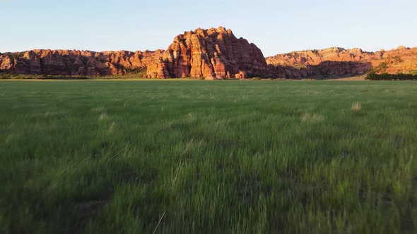 A red rock mountain at sunset in Zion National Park, Utah. Drone shot flying fast alt